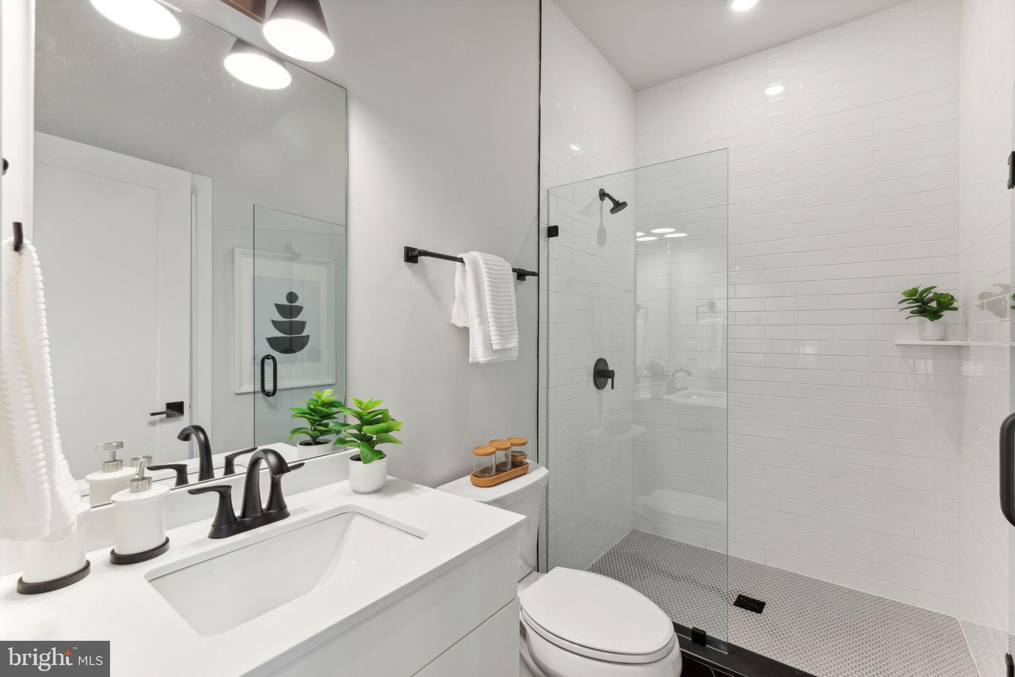 6910 Ridge Avenue, Unit 418 Philadelphia, PA 19128 - Photo 18 of 26 a bathroom with a sink a toilet and shower