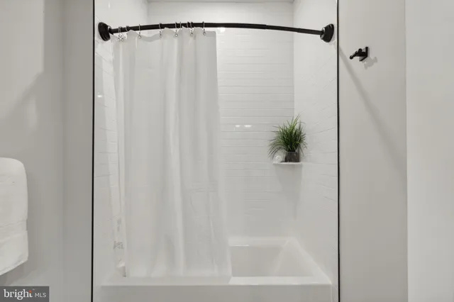 a bathroom with a shower and a shower curtain