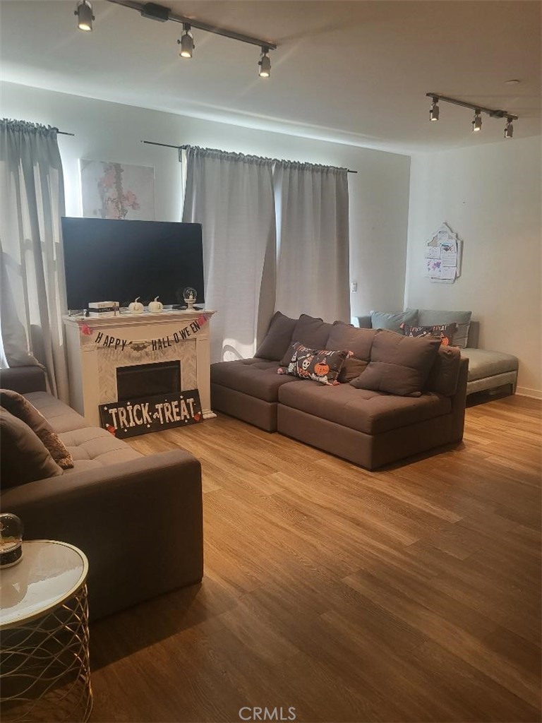 612 East Carson Street, Unit 202 Carson, CA 90745 - Photo 11 of 24 a living room with furniture and a flat screen tv