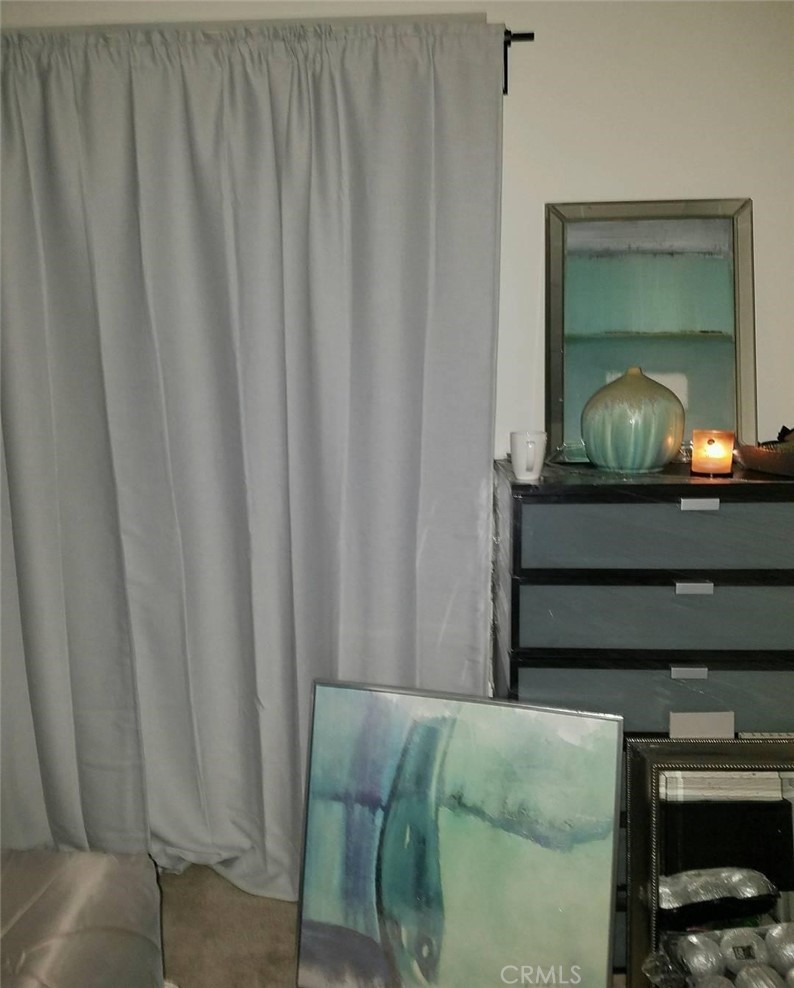 612 East Carson Street, Unit 202 Carson, CA 90745 - Photo 15 of 24 a living room with a bed furniture and a window