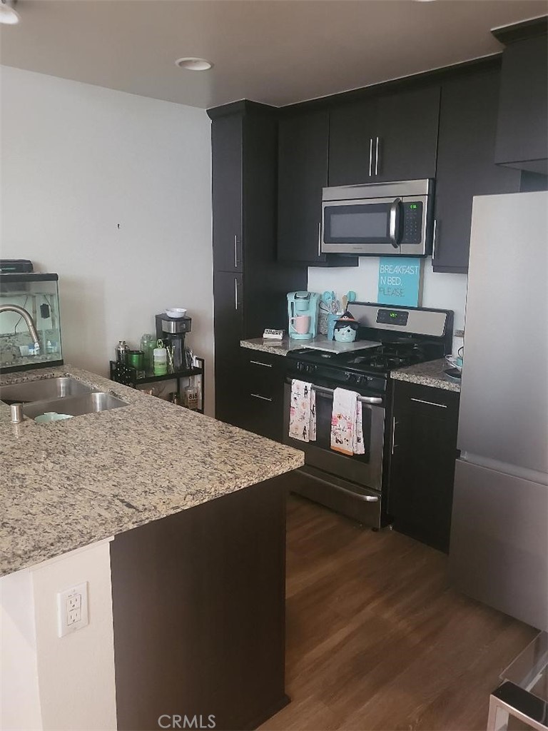 612 East Carson Street, Unit 202 Carson, CA 90745 - Photo 16 of 24 a kitchen with stainless steel appliances granite countertop a sink stove and refrigerator