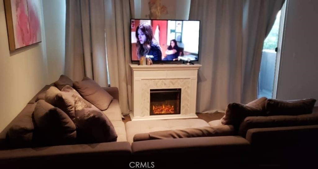 612 East Carson Street, Unit 202 Carson, CA 90745 - Photo 4 of 24 a living room with furniture and a fireplace