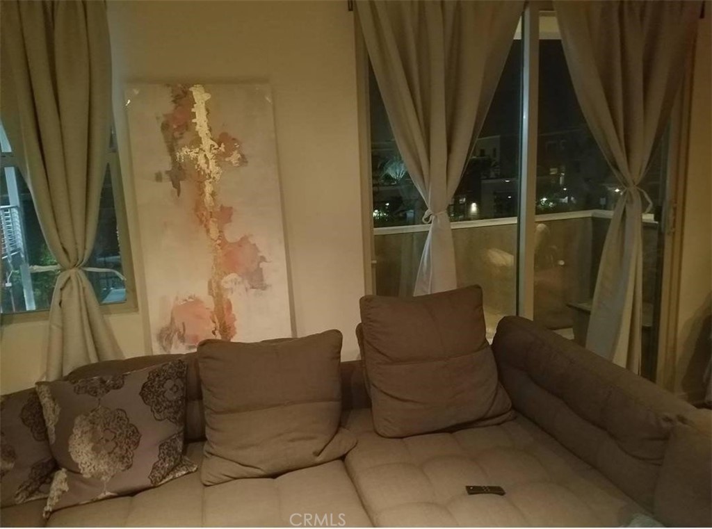 612 East Carson Street, Unit 202 Carson, CA 90745 - Photo 6 of 24 a living room with furniture and a floor to ceiling window