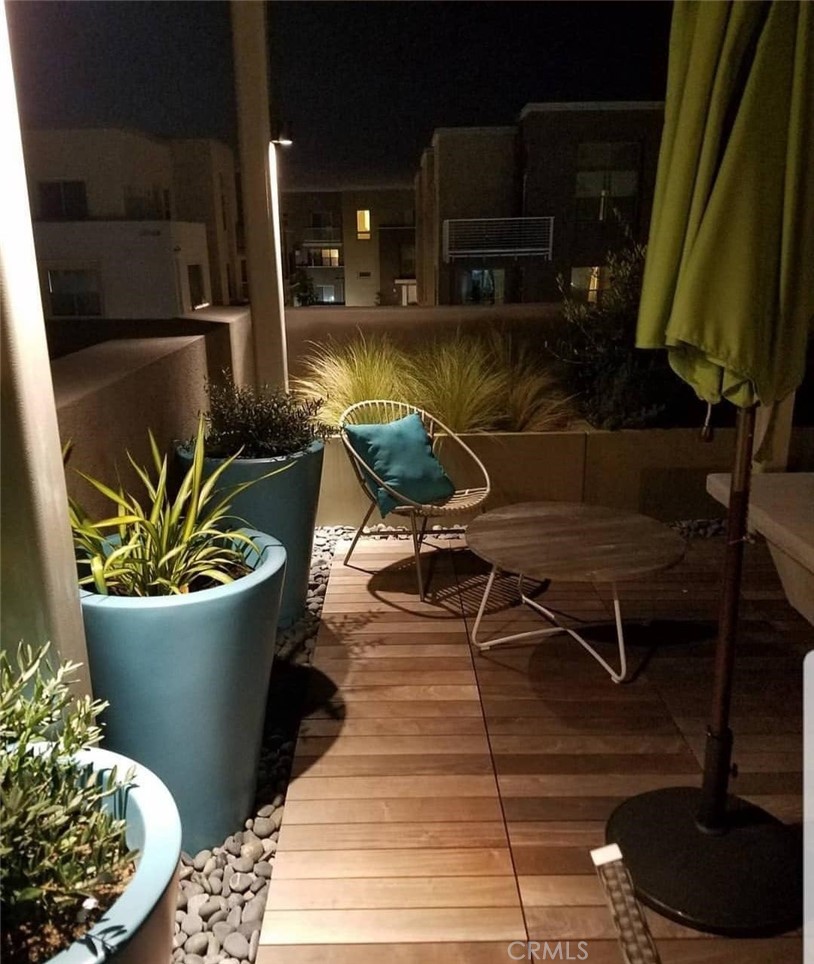 612 East Carson Street, Unit 202 Carson, CA 90745 - Photo 9 of 24 a view of a balcony with chair and potted plants