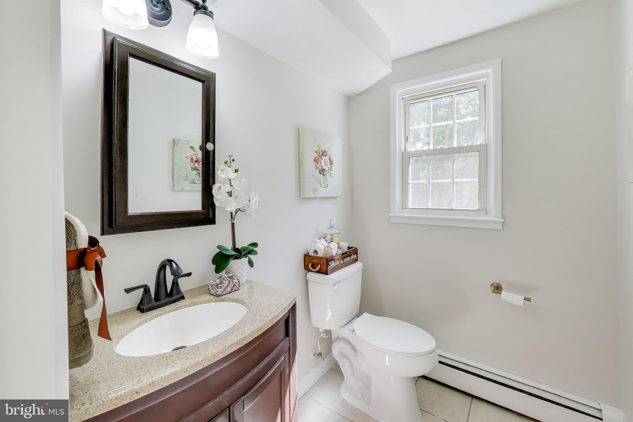 2107 Patrick Street Woodbridge, VA 22191 - Photo 23 of 28 a bathroom with a sink vanity mirror and toilet