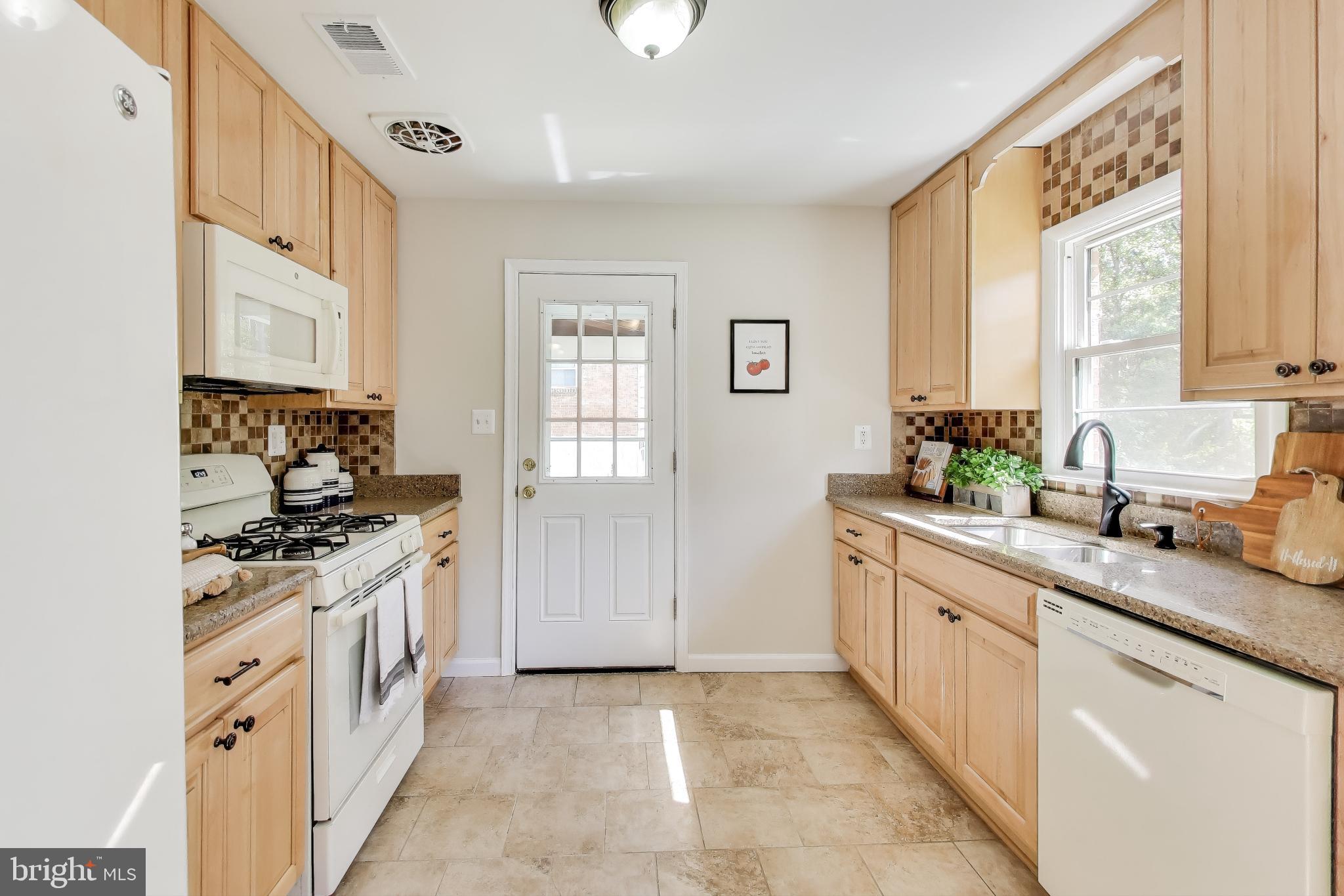 2107 Patrick Street Woodbridge, VA 22191 - Photo 6 of 28 a kitchen with stainless steel appliances granite countertop a stove and a sink