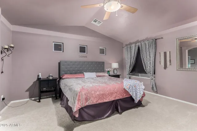 a bedroom with a bed a table and chair