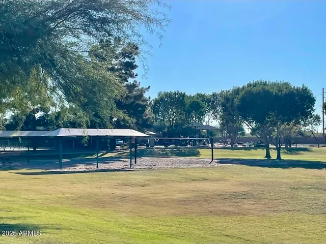 a view of a swimming pool with an outdoor seating and a yard