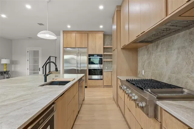a kitchen with granite countertop a stove and a sink