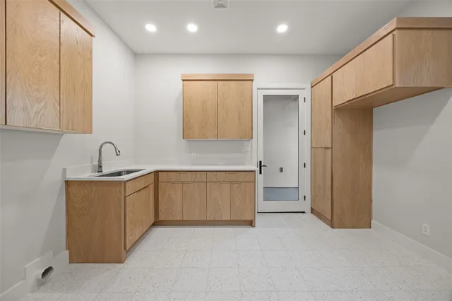 a kitchen with a sink and cabinets