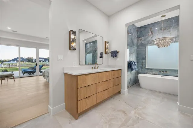 a bathroom with a tub sink and mirror