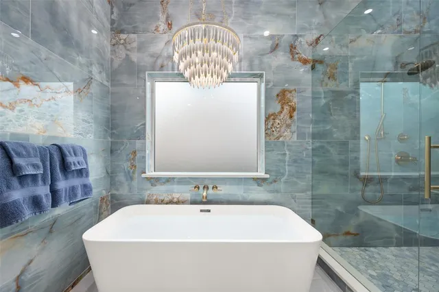 a bath tub sitting next to a white sink