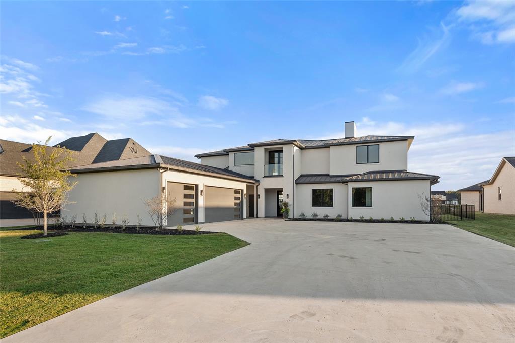 1532 Laguna Bay West Azle, TX 76020 - Photo 2 of 40 a front view of a house with a garden and yard