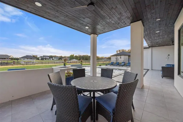 a dining room with furniture and a floor to ceiling window