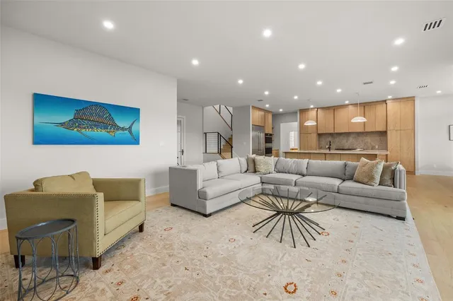 a living room with furniture and kitchen view