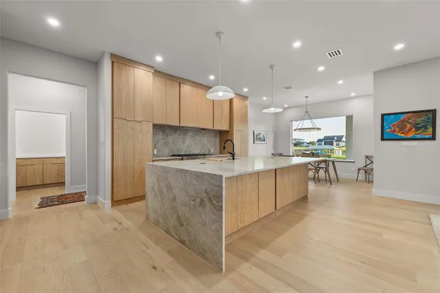 a kitchen with kitchen island cabinets and refrigerator