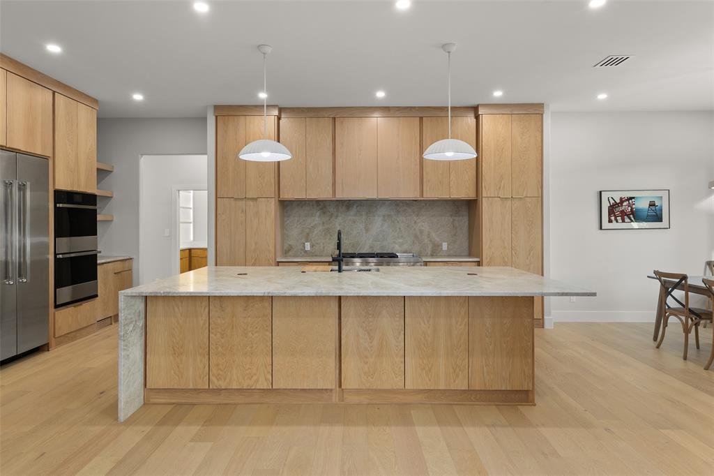1532 Laguna Bay West Azle, TX 76020 - Photo 10 of 40 a view of a kitchen with kitchen island a sink stainless steel appliances and cabinets