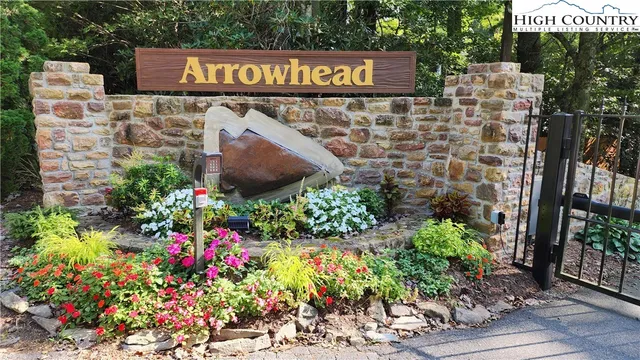a street sign that is sitting in front of flowers