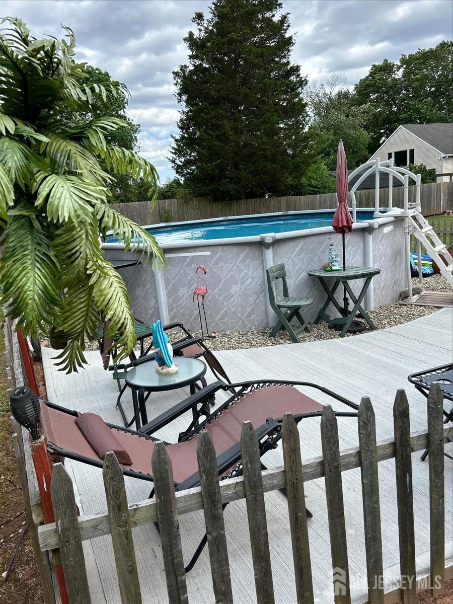 33 Ellison Road Somerset, NJ 08873 - Photo 31 of 38 a roof deck with table and chairs under an umbrella