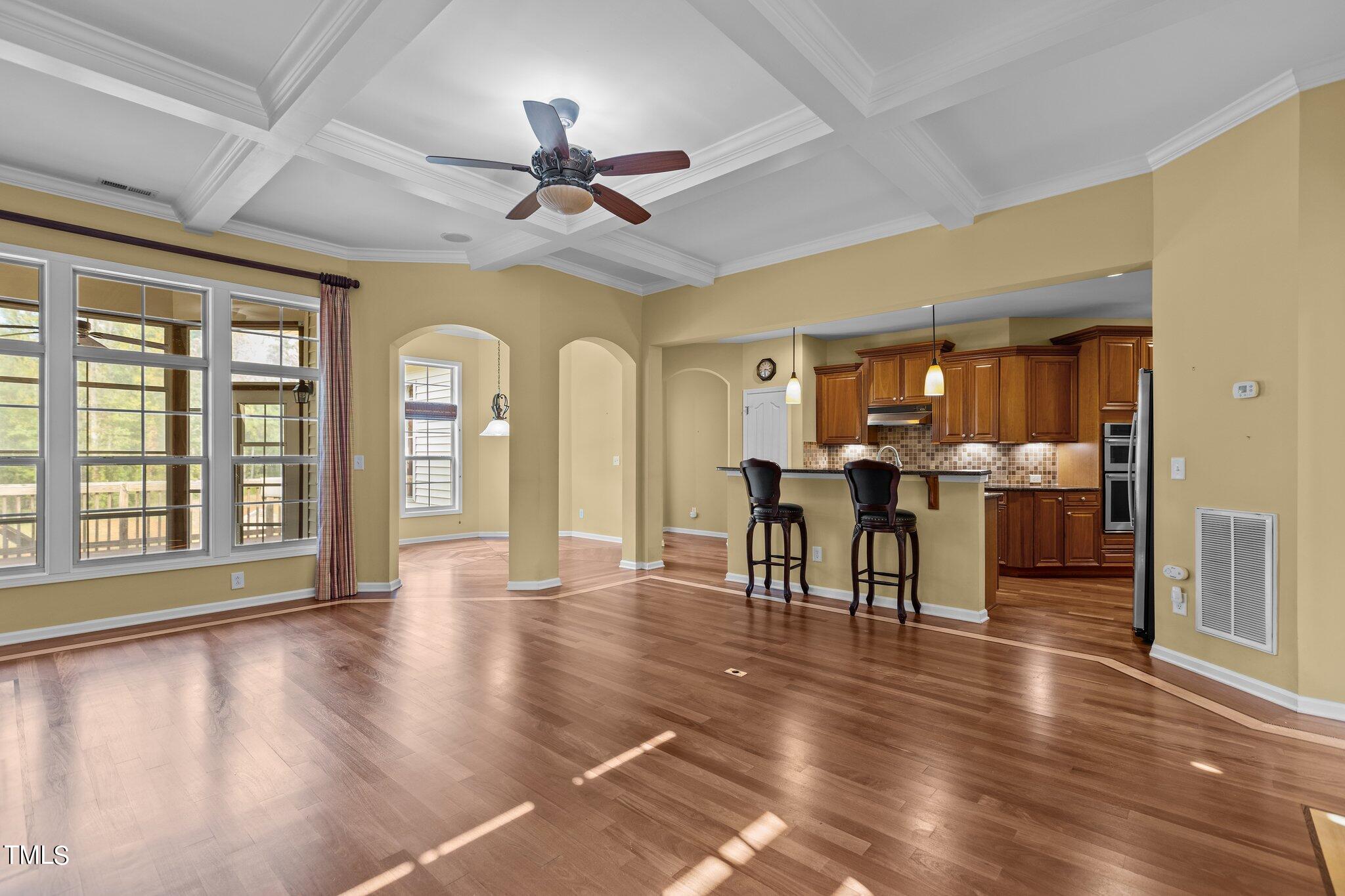 6112 Blakeman Lane Raleigh, NC 27617 - Photo 14 of 56 a dining room with wooden floor a chandelier a glass table and chairs