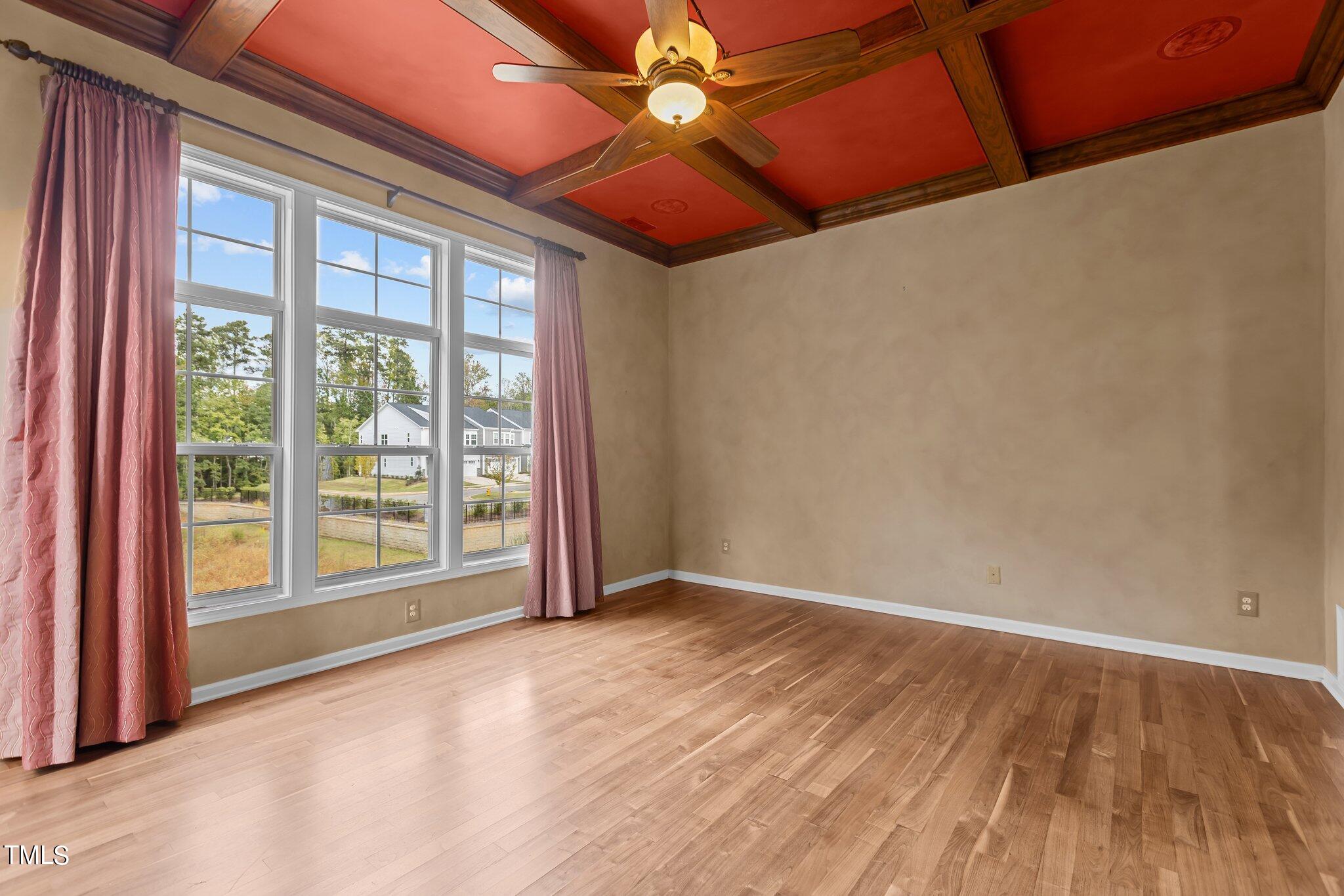 6112 Blakeman Lane Raleigh, NC 27617 - Photo 25 of 56 an empty room with windows and ceiling fan