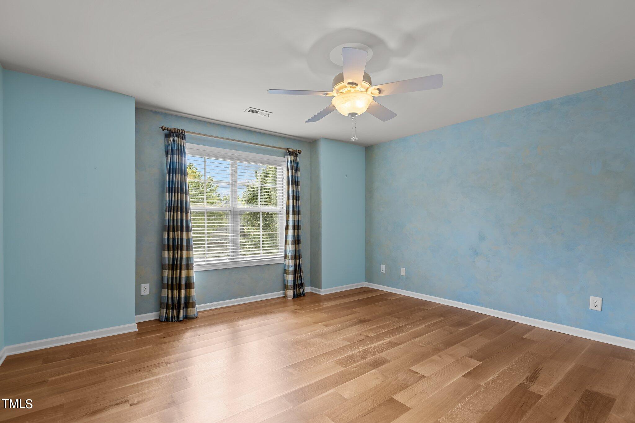 6112 Blakeman Lane Raleigh, NC 27617 - Photo 36 of 56 wooden floor in an empty room with a window