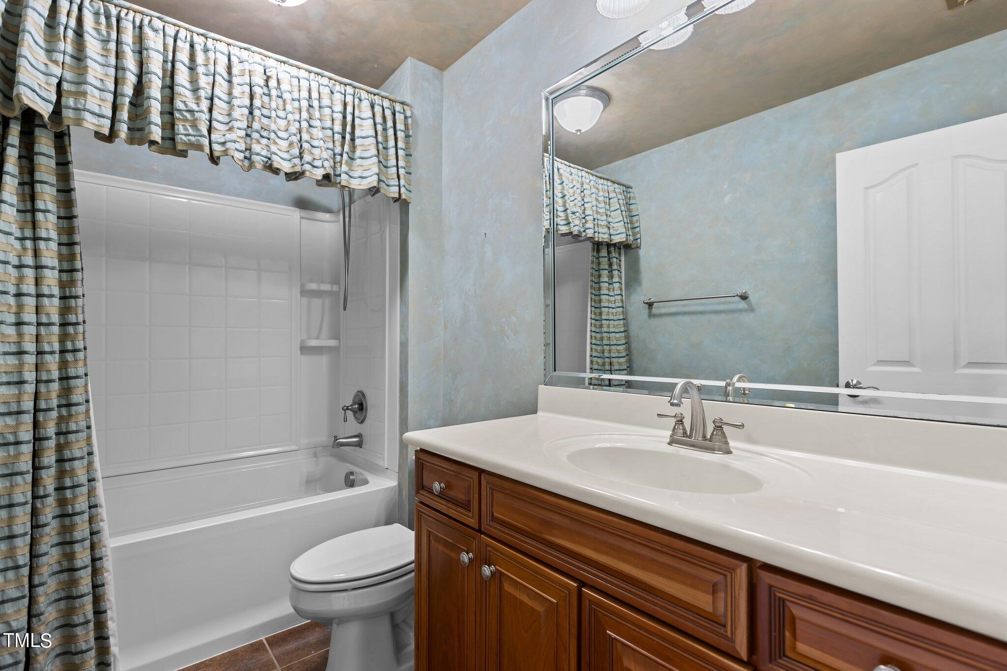 6112 Blakeman Lane Raleigh, NC 27617 - Photo 38 of 56 a bathroom with a sink a toilet and shower