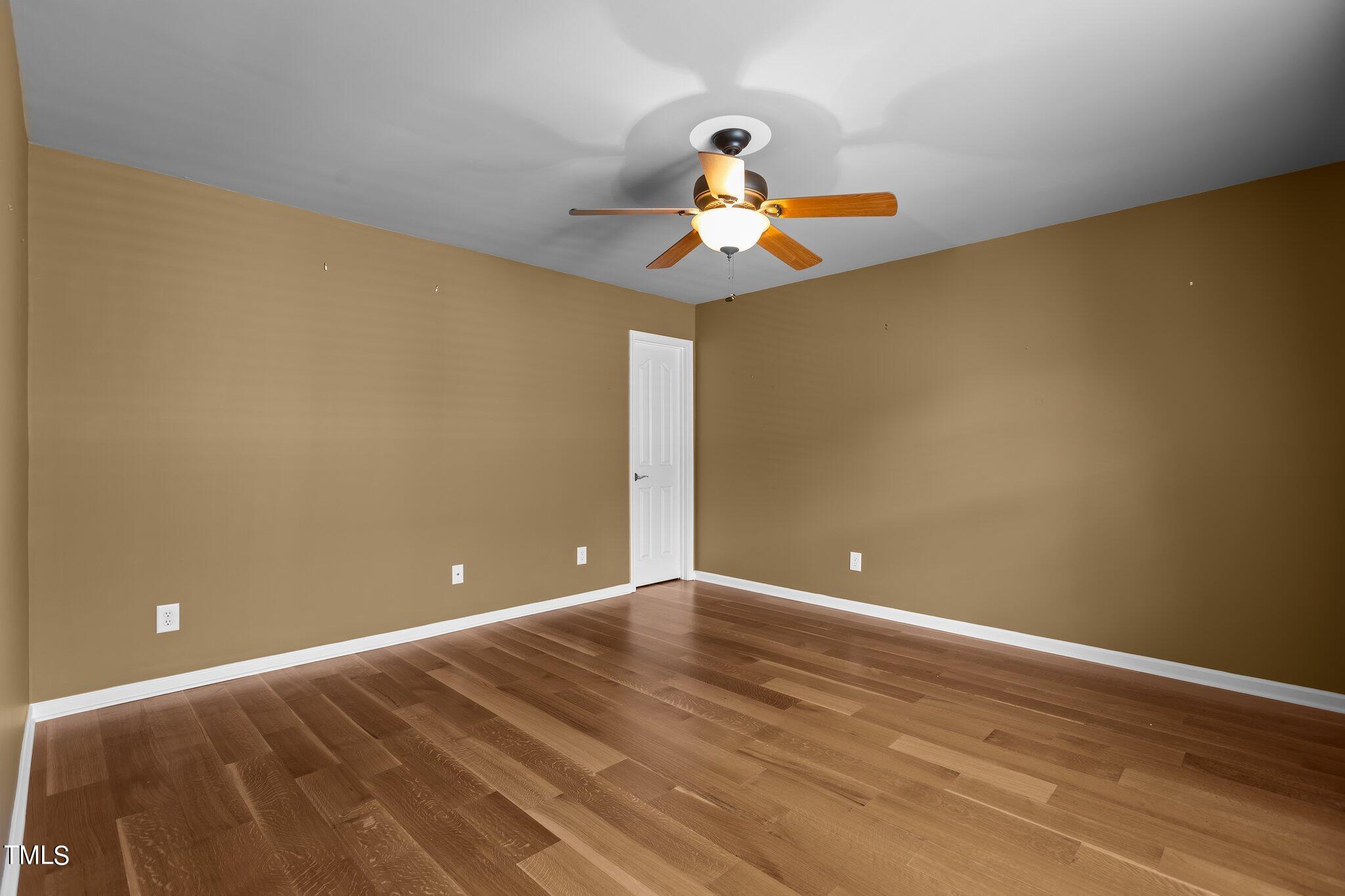 6112 Blakeman Lane Raleigh, NC 27617 - Photo 40 of 56 a view of an empty room with wooden floor