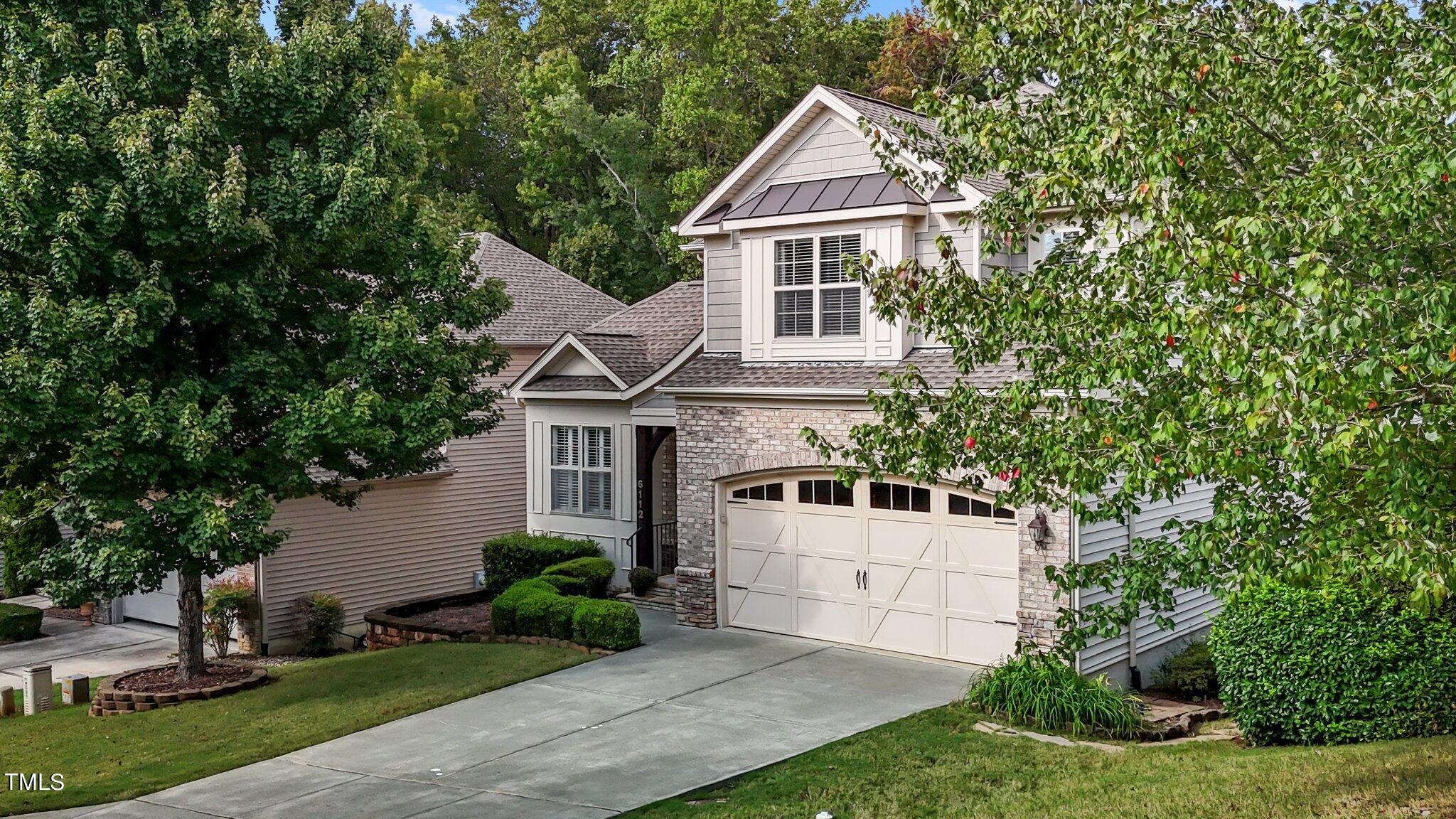 6112 Blakeman Lane Raleigh, NC 27617 - Photo 4 of 56 a view of white house with a yard and potted plants