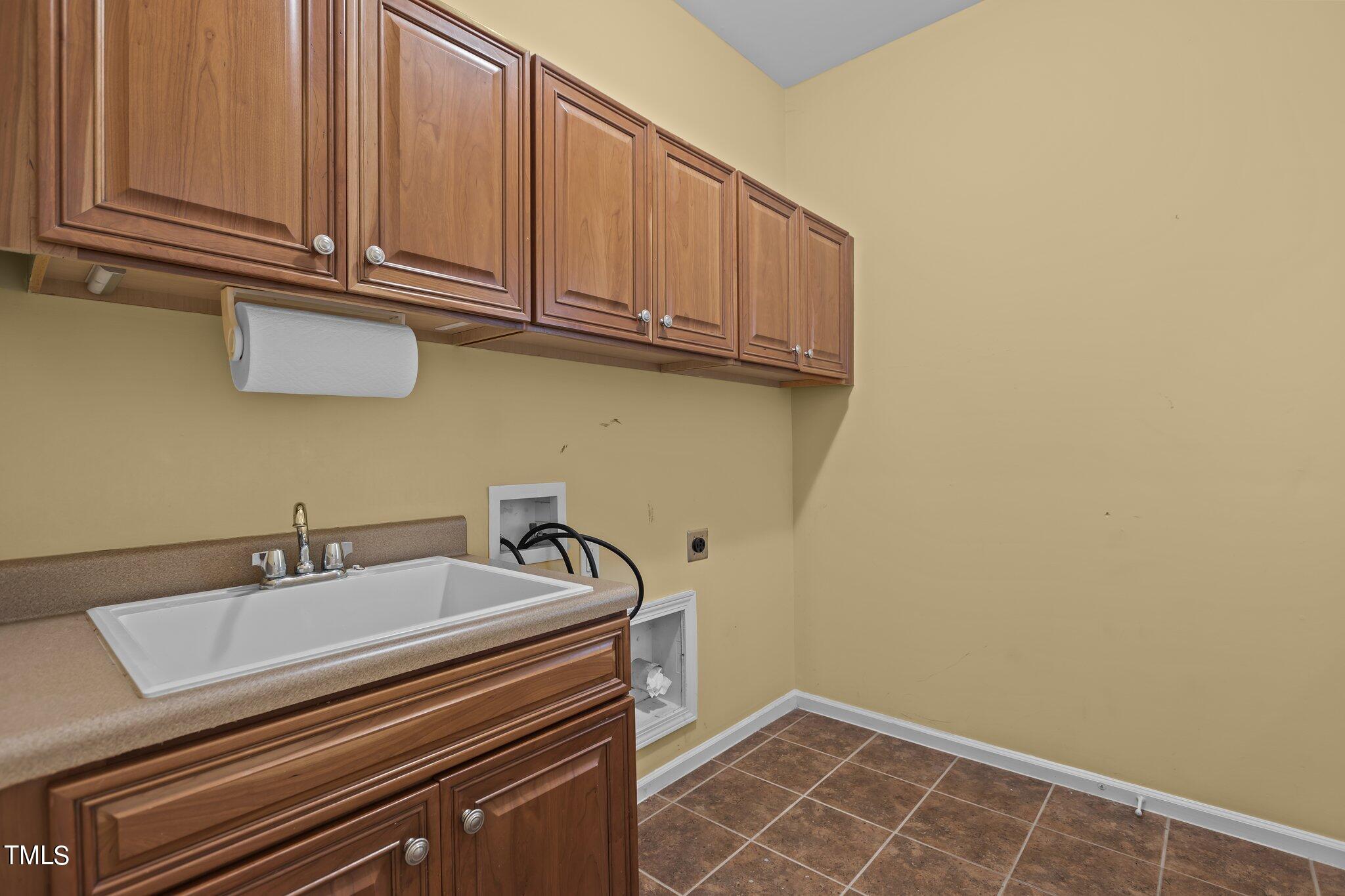 6112 Blakeman Lane Raleigh, NC 27617 - Photo 42 of 56 a bathroom with a sink and cabinets