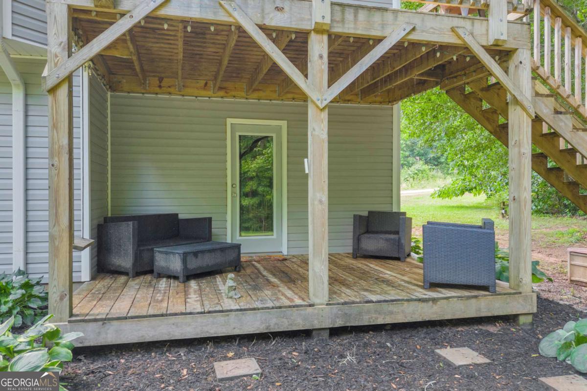 335 Elizabeth Court Colbert, GA 30628 - Photo 28 of 33 a view of house with a floor to ceiling windows and wooden fence