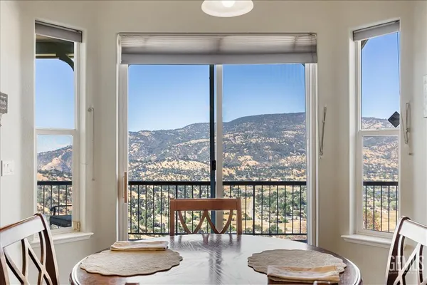 a kitchen with stainless steel appliances granite countertop a refrigerator a sink a stove a microwave and wooden cabinets