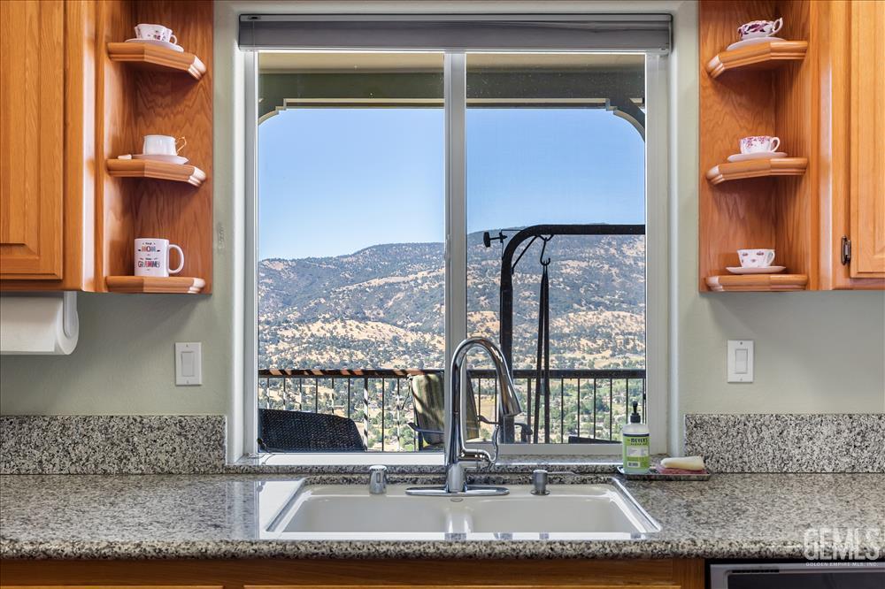 Undisclosed Address Tehachapi, CA 93561 - Photo 19 of 62 a bathroom with a granite countertop sink and a mirror