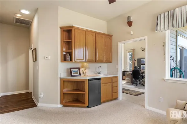 a work room with furniture and a large window