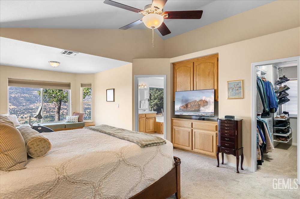 Undisclosed Address Tehachapi, CA 93561 - Photo 34 of 62 a bedroom with a large bed and a chandelier