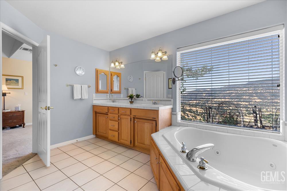 Undisclosed Address Tehachapi, CA 93561 - Photo 38 of 62 a bathroom with a tub sink and mirror