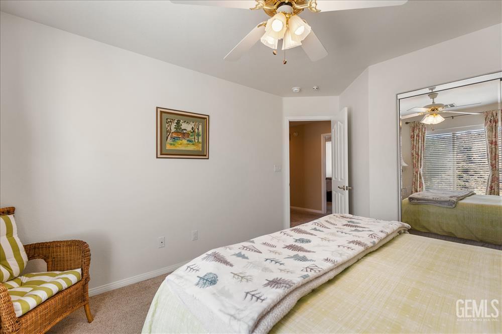 Undisclosed Address Tehachapi, CA 93561 - Photo 42 of 62 a bedroom with a bed and a chandelier