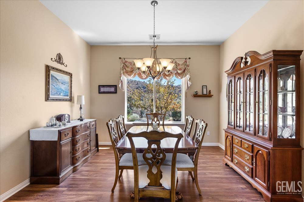 Undisclosed Address Tehachapi, CA 93561 - Photo 9 of 62 a dining room with furniture a chandelier and wooden floor