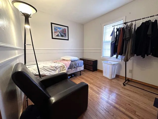 a bed room with furniture and a air conditioner