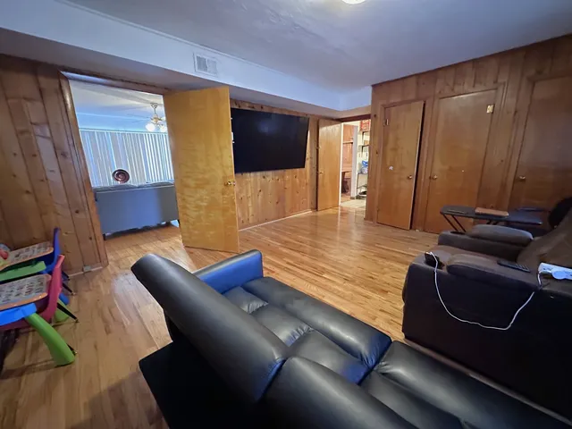 a living room with furniture rug and a flat screen tv
