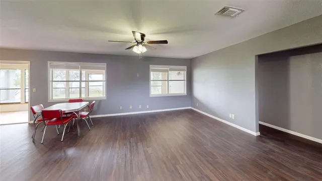 a view of a livingroom with furniture window and wooden floor