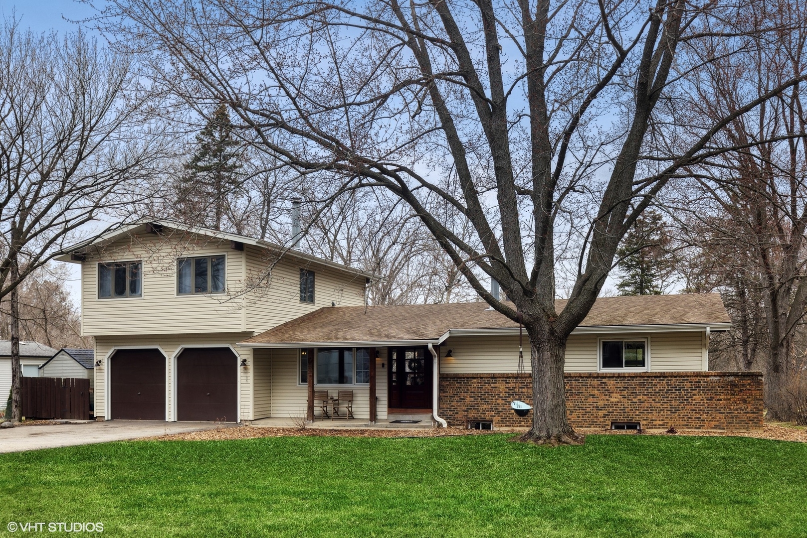 a front view of house with yard and green space