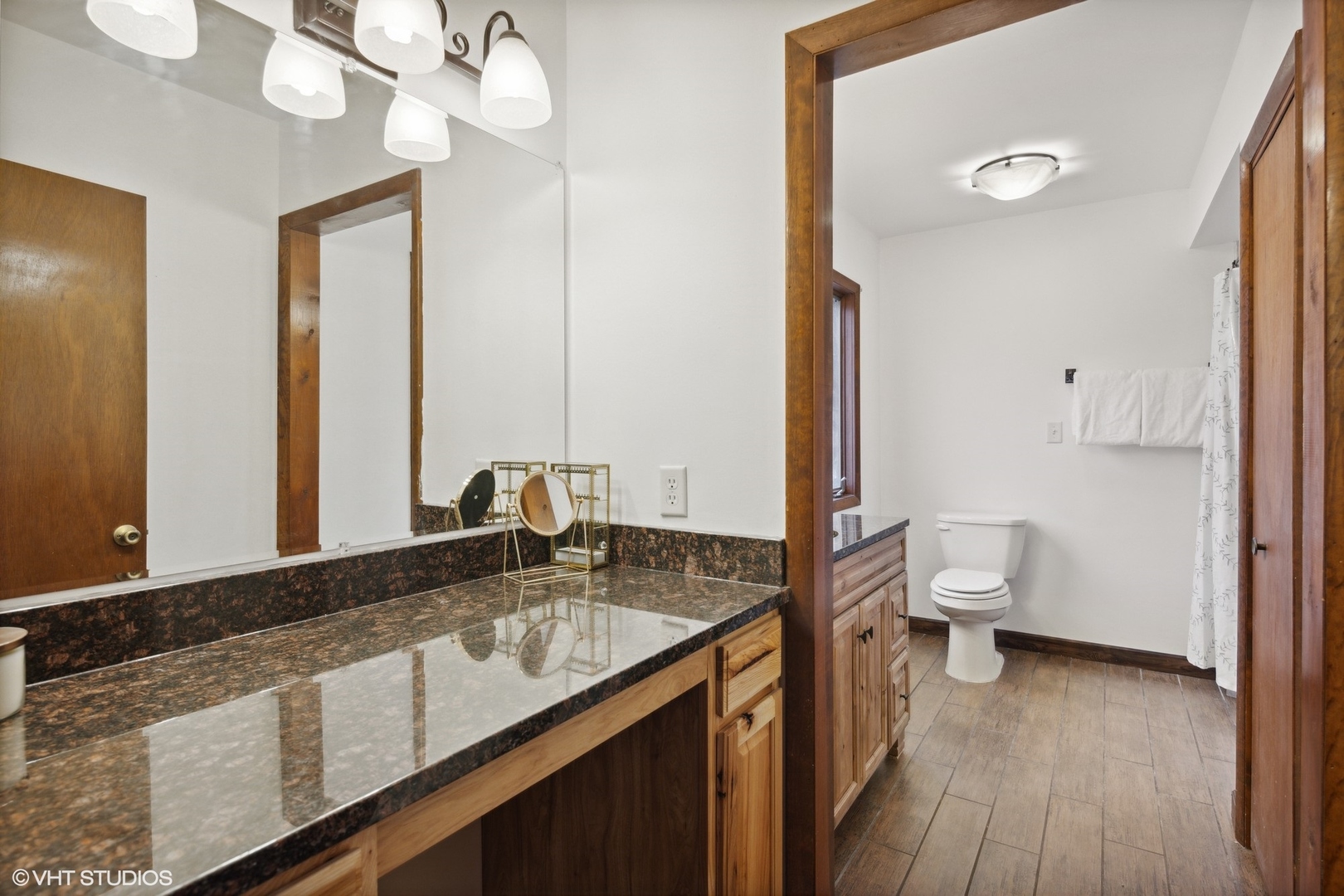 607 Pine Street Batavia, IL 60510 - Photo 22 of 39 a bathroom with a granite countertop sink a toilet and a large mirror