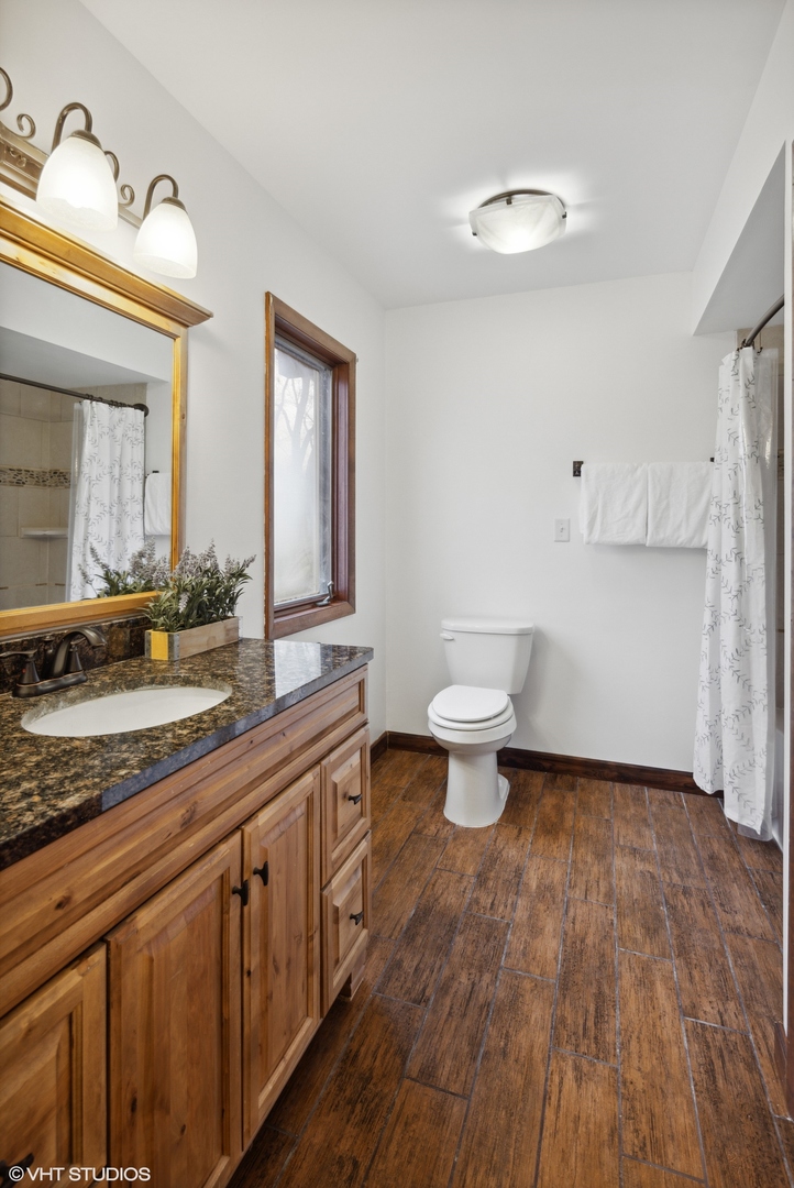607 Pine Street Batavia, IL 60510 - Photo 24 of 39 a bathroom with a sink and a mirror