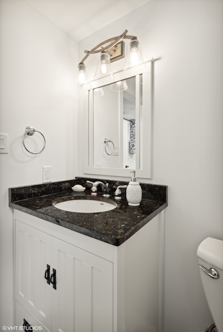 607 Pine Street Batavia, IL 60510 - Photo 32 of 39 a bathroom with a granite countertop sink and a mirror