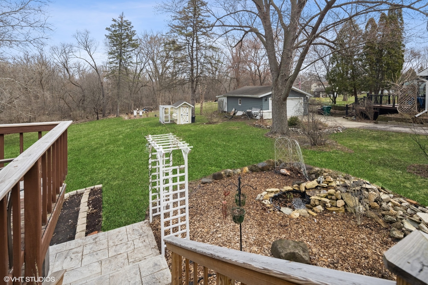 607 Pine Street Batavia, IL 60510 - Photo 35 of 39 a view of a garden with a bench in front of a house