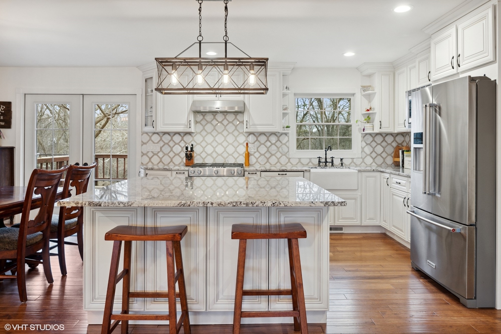607 Pine Street Batavia, IL 60510 - Photo 5 of 39 a kitchen with stainless steel appliances granite countertop a dining table chairs and refrigerator