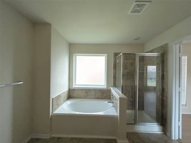 a bathroom with a bathtub and a shower