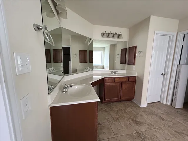 a kitchen with stainless steel appliances a sink and a refrigerator