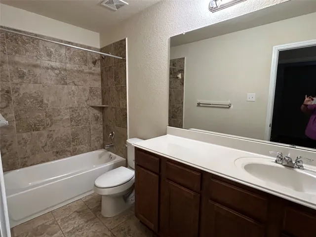 a bathroom with a sink a toilet and a bathtub